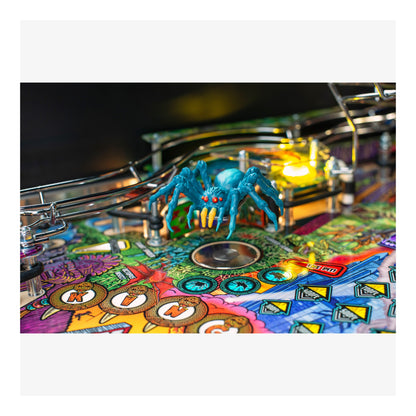 Close-up of a colorful pinball machine with a blue spider figure.