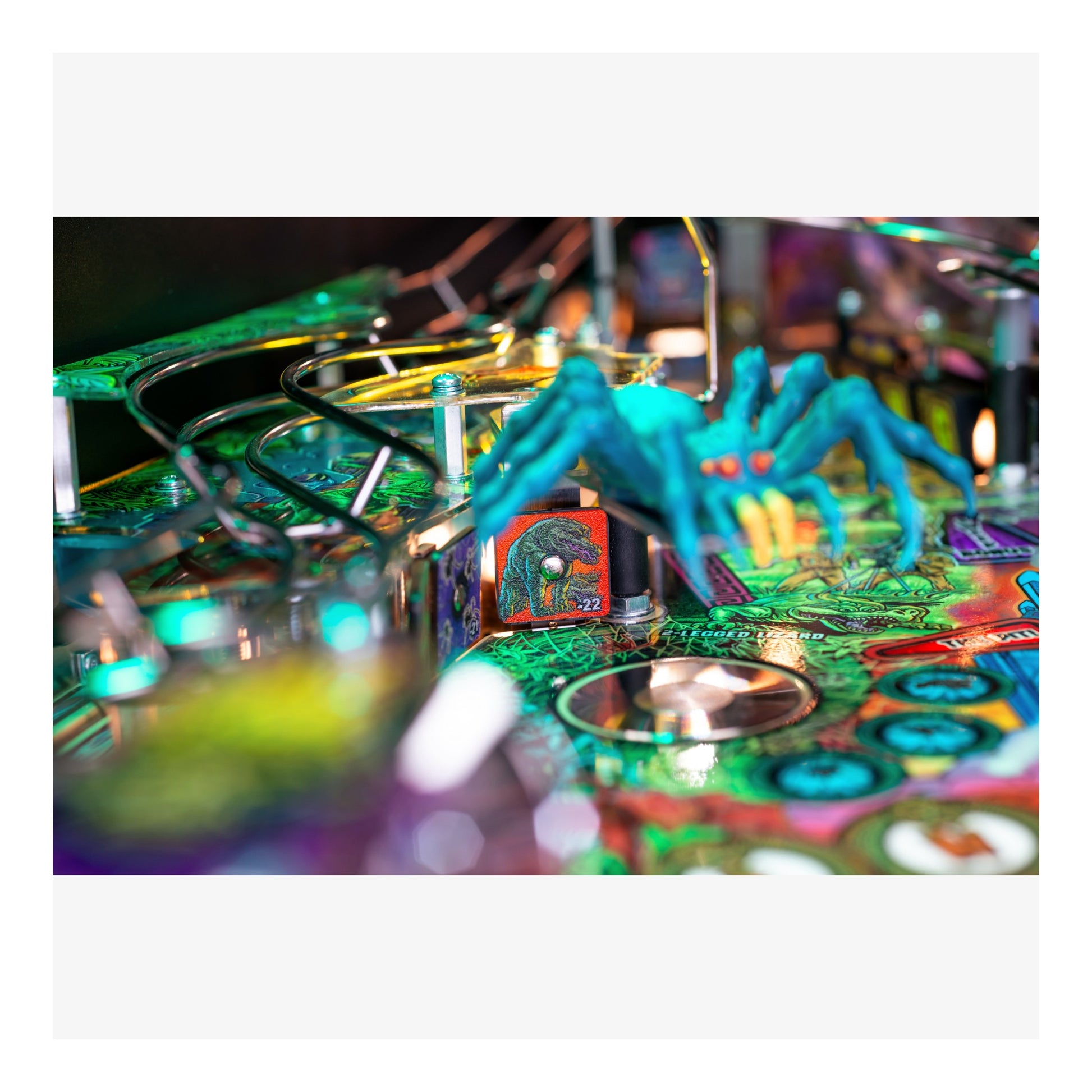 Colorful pinball machine with a player in blue gloves about to hit a ball.