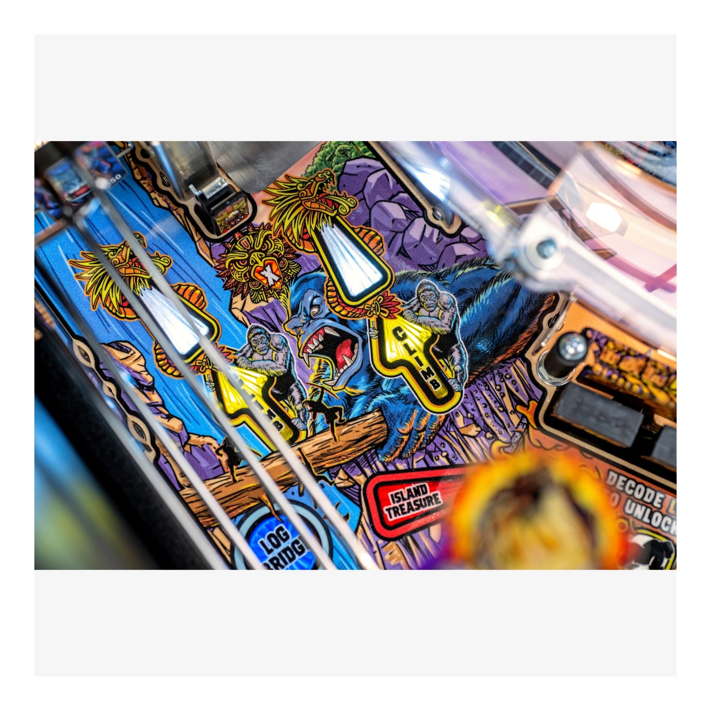Colorful pinball machine with detailed artwork and text on a white background