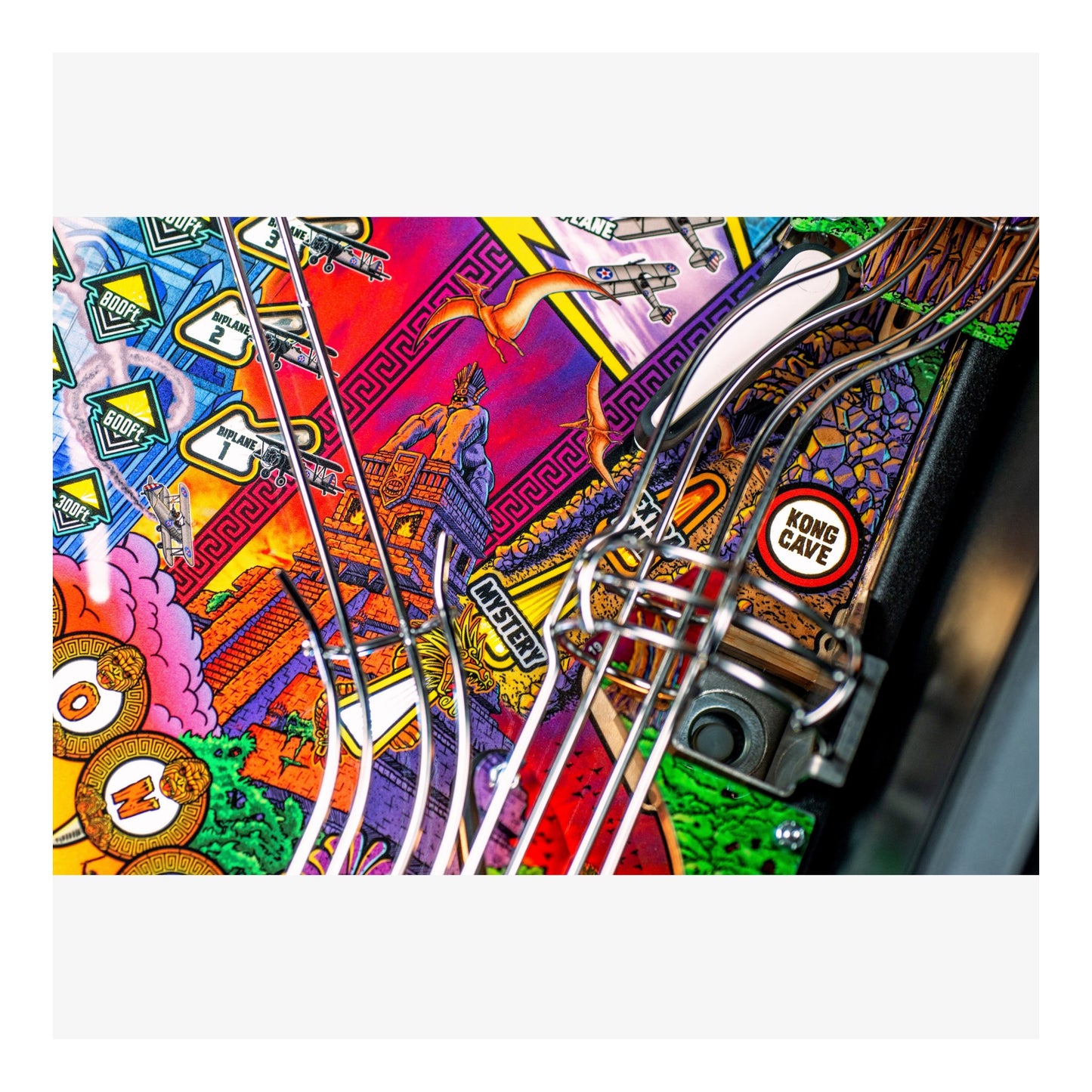 Colorful pinball machine with various designs and a 'Kong Cave' button.