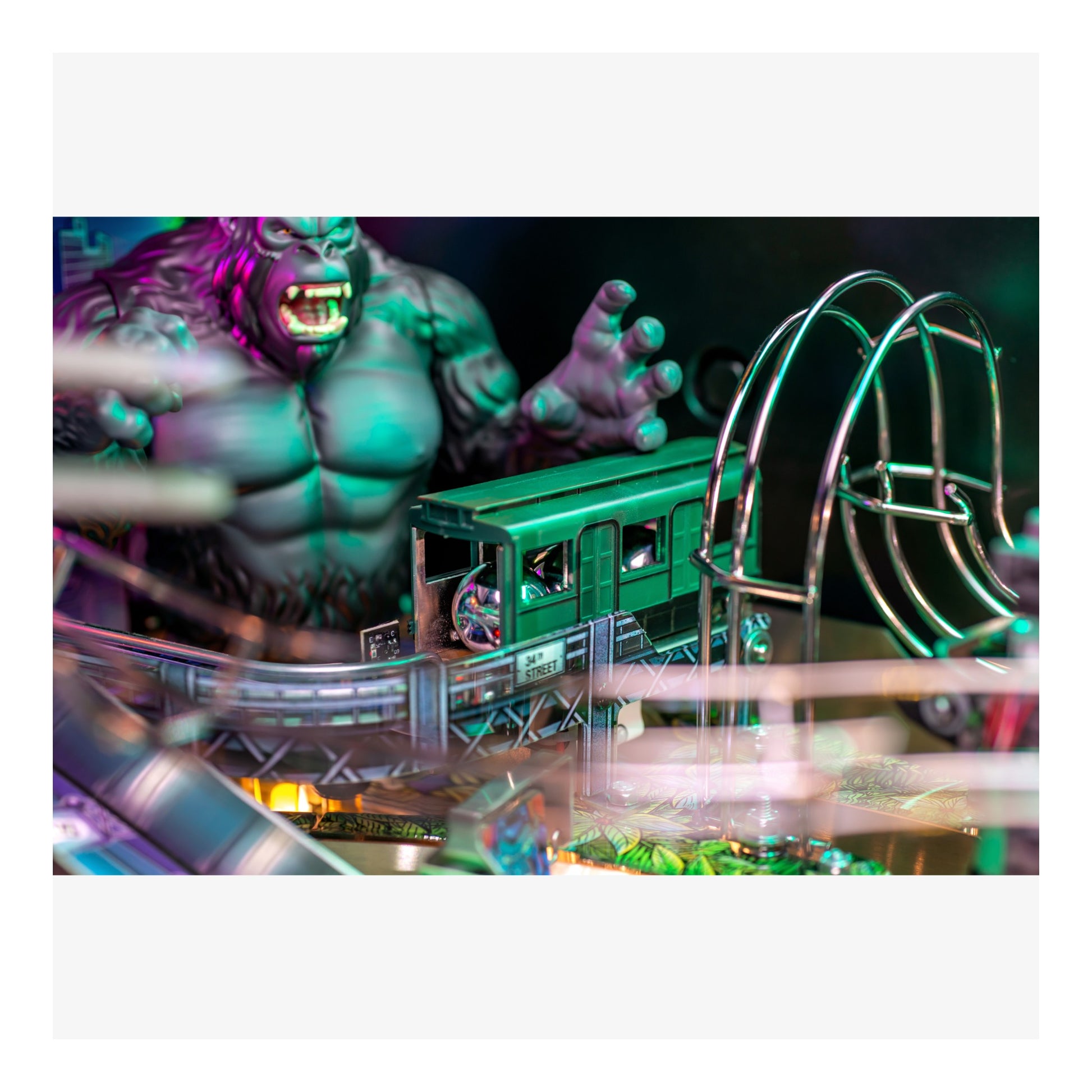 Superhero action figure with a green train set in the background