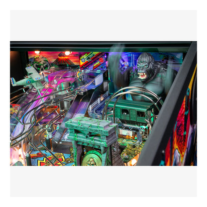 Close-up of a colorful pinball machine with a large green monster figure.