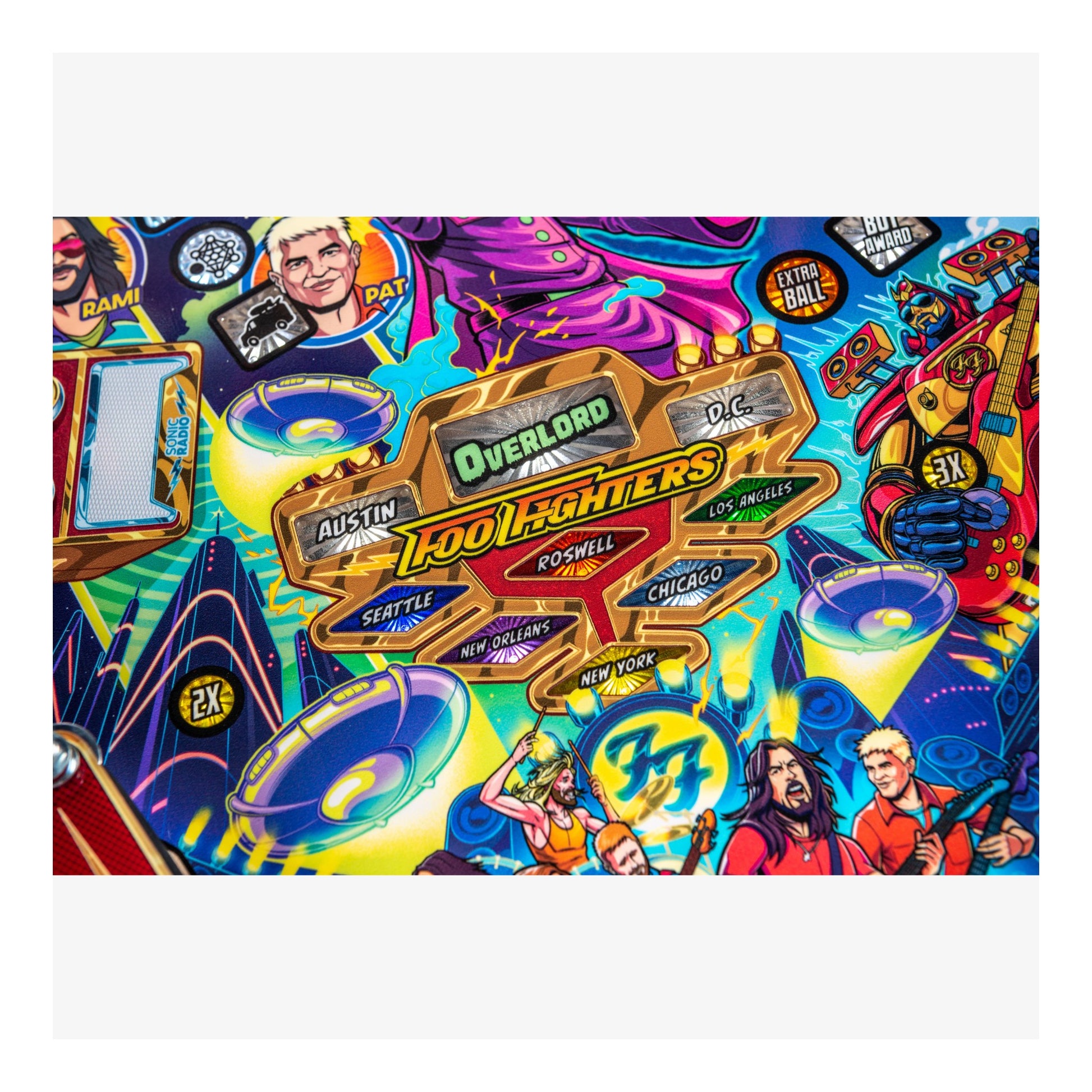 Colorful pinball machine layout with various characters and logos.