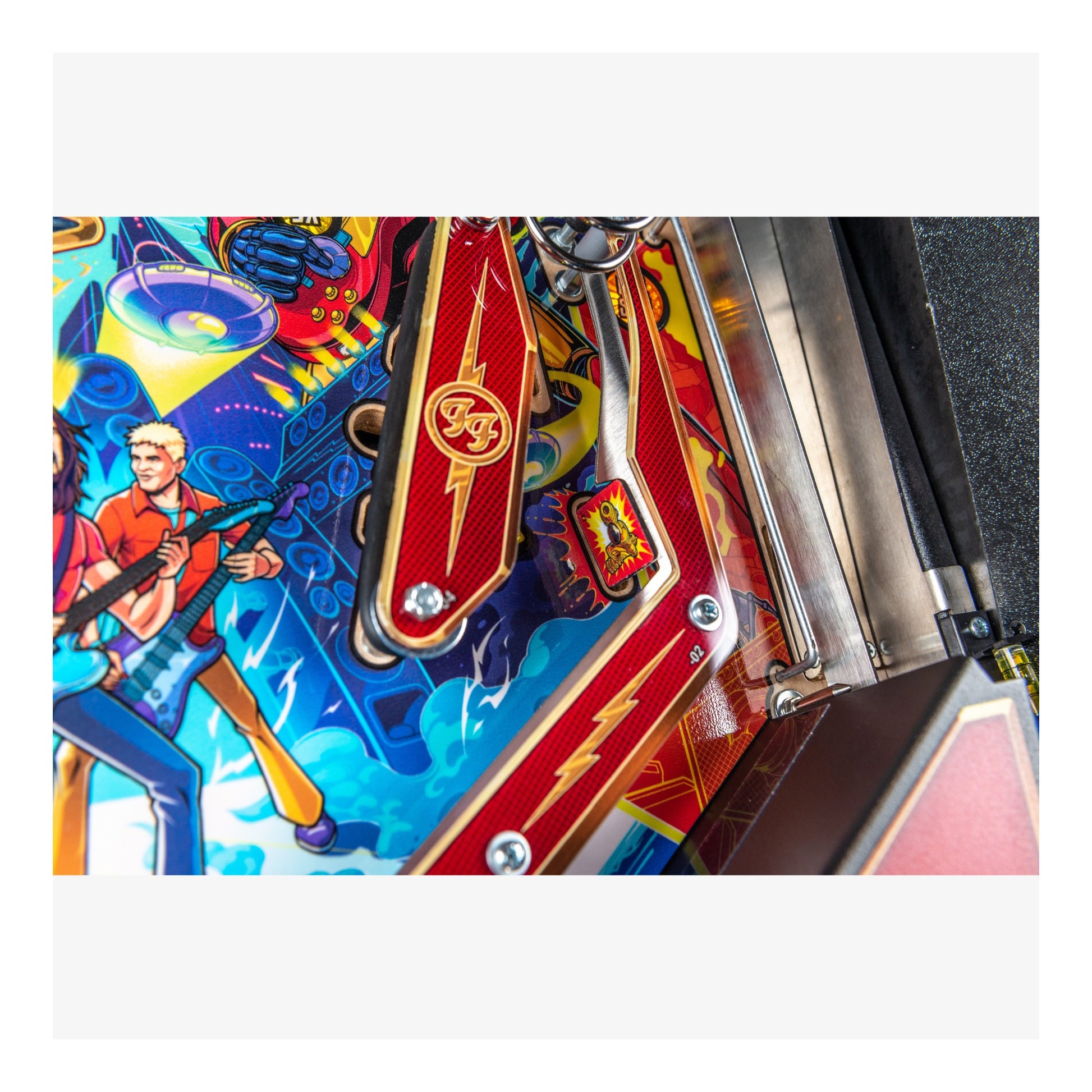 Close-up of a colorful pinball machine with vibrant graphics and branding.