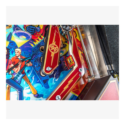 Close-up of a colorful pinball machine with vibrant graphics and branding.