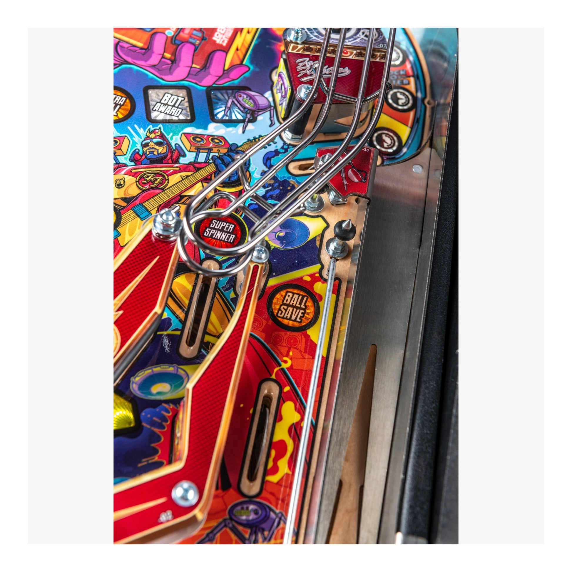 Close-up of a colorful pinball machine with various components.