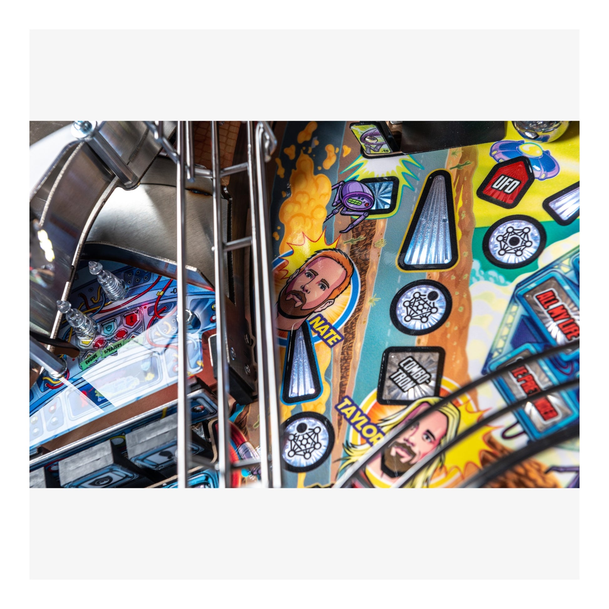 Close-up of a colorful pinball machine with various symbols and designs.