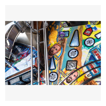 Close-up of a colorful pinball machine with various symbols and designs.