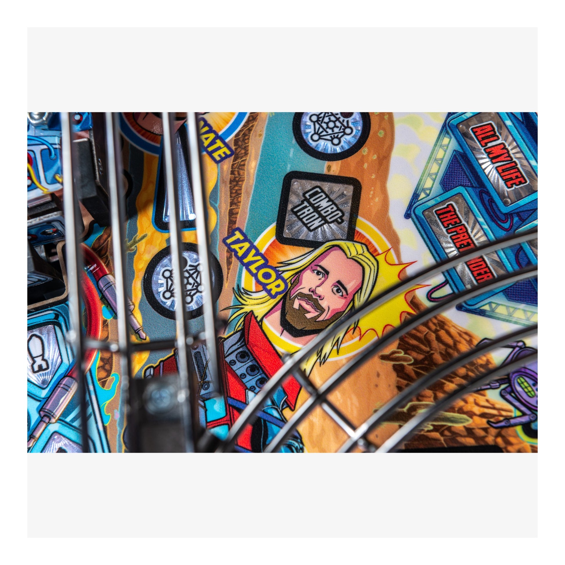 Close-up of a colorful pinball machine with a character illustration and various game elements.