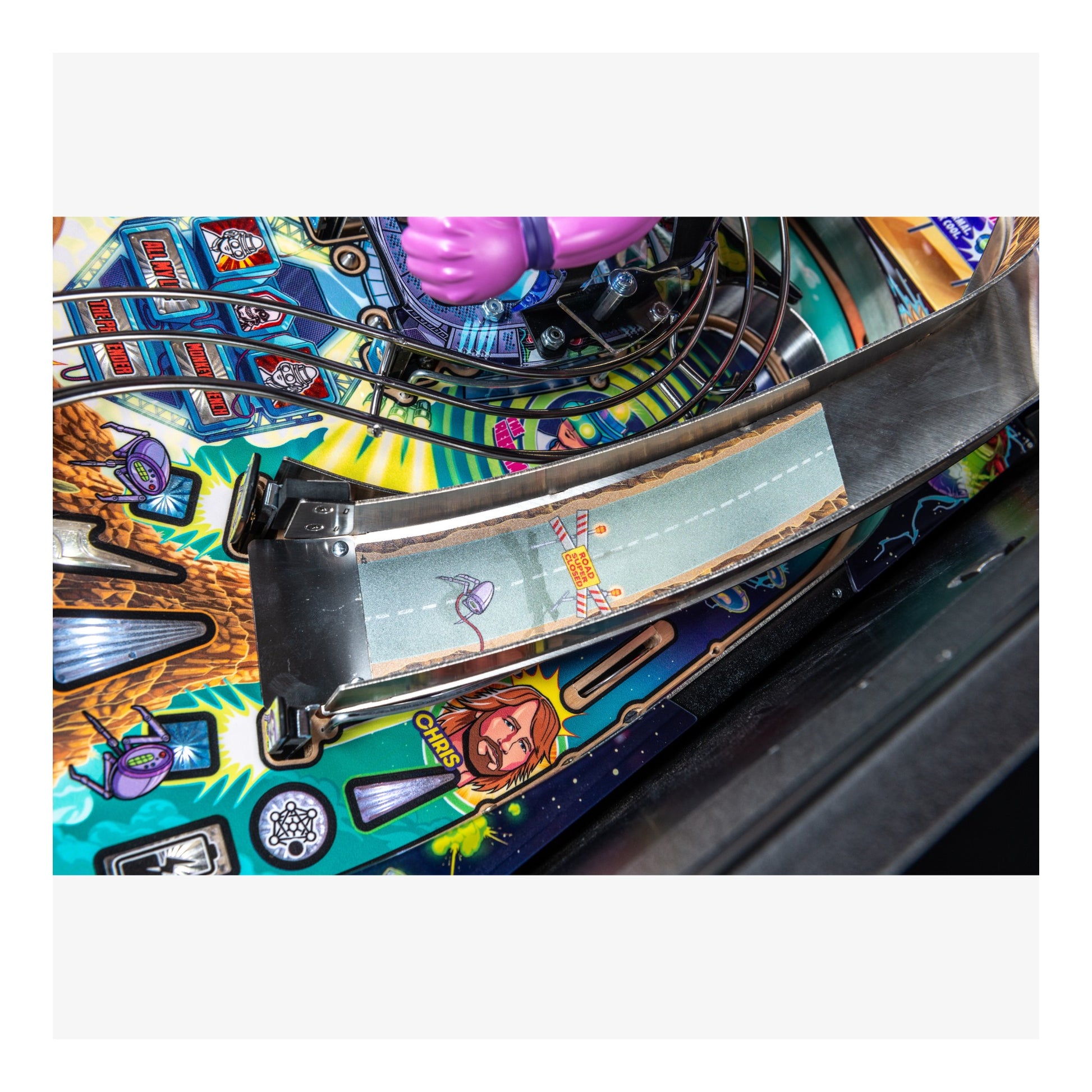 Close-up of a colorful pinball machine with detailed artwork