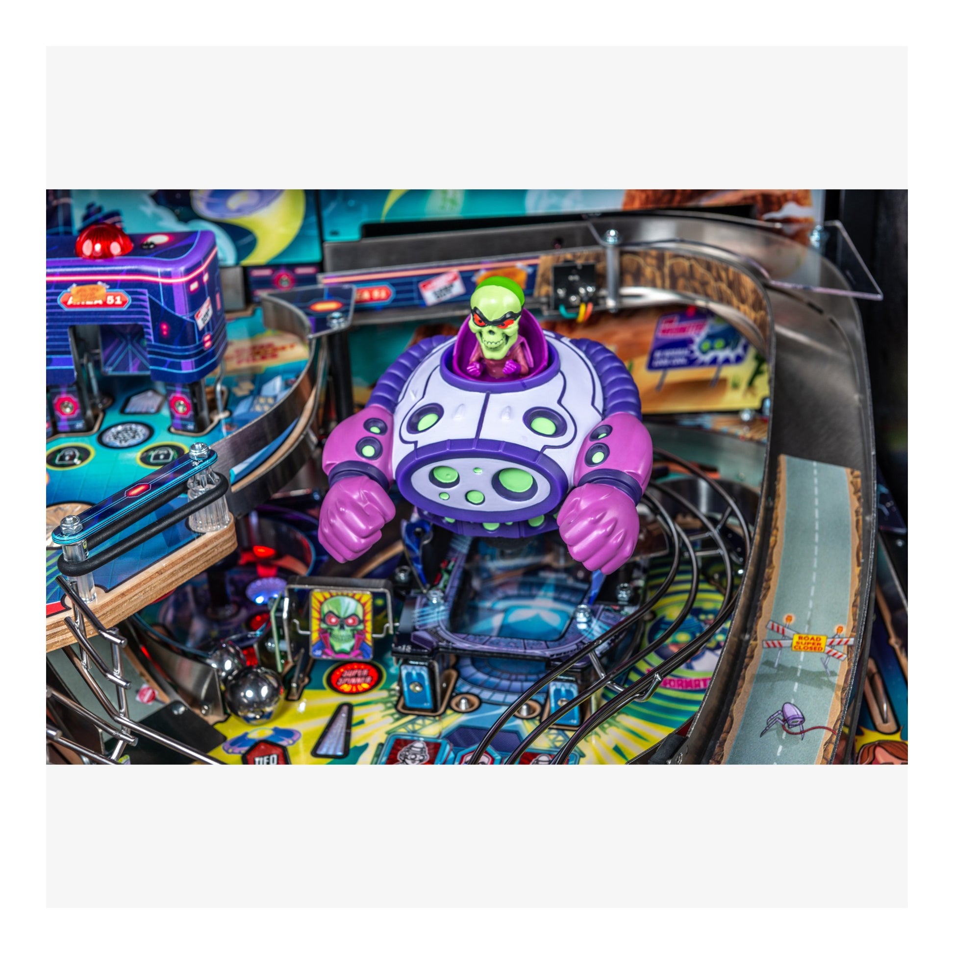 Pinball machine with a colorful alien figure on the playfield
