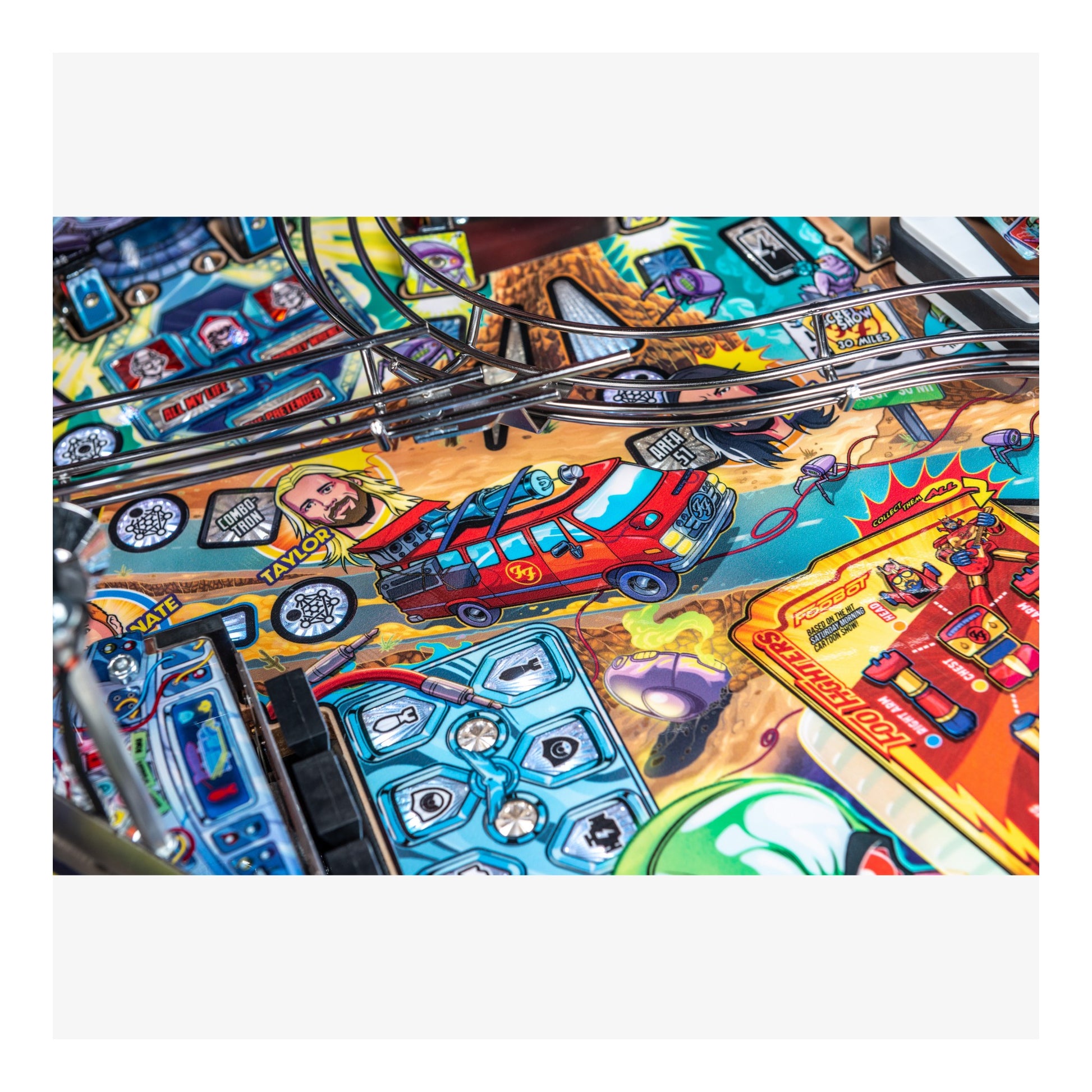 Close-up of a colorful pinball machine with various symbols and graphics.