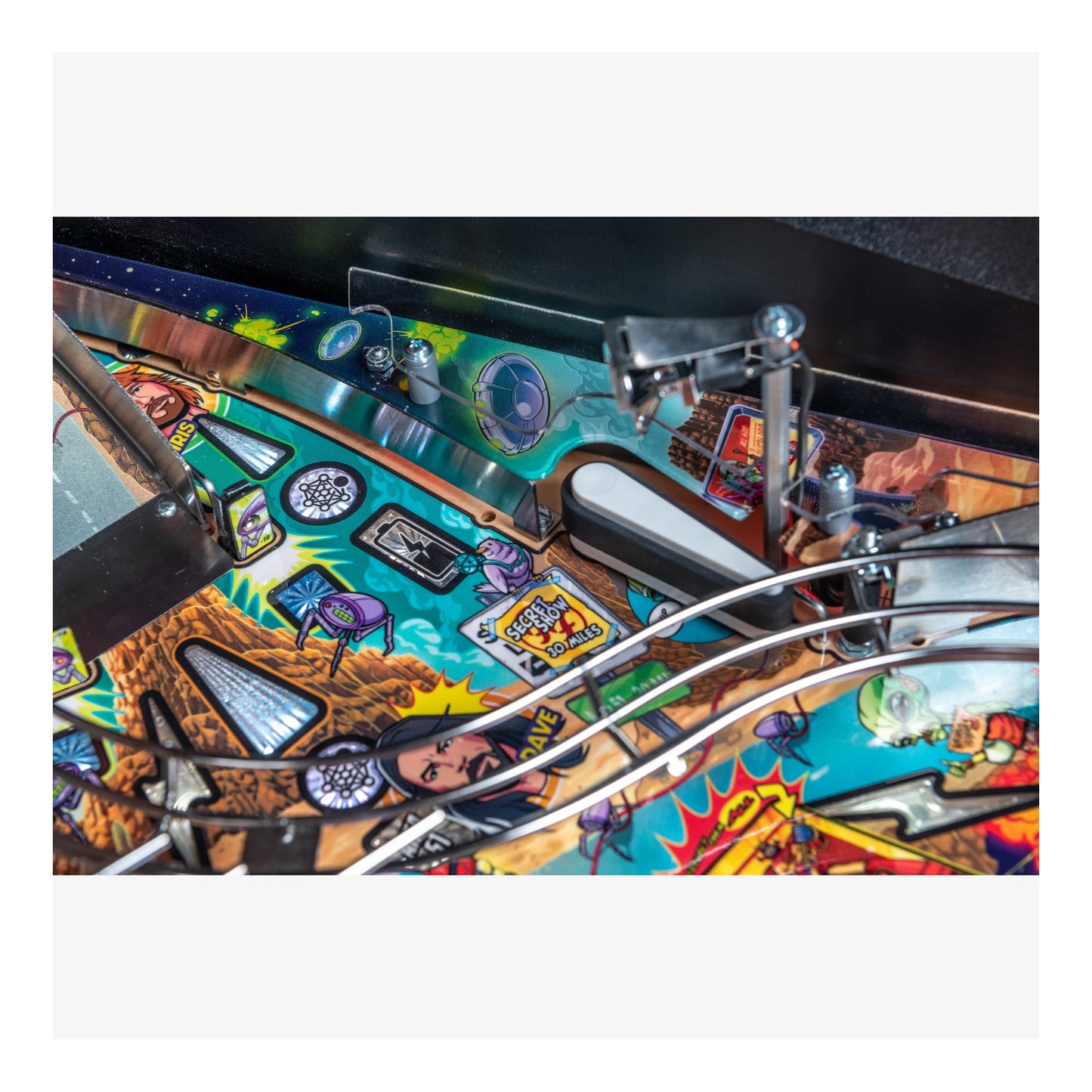 Close-up of a colorful pinball machine with various symbols and designs.