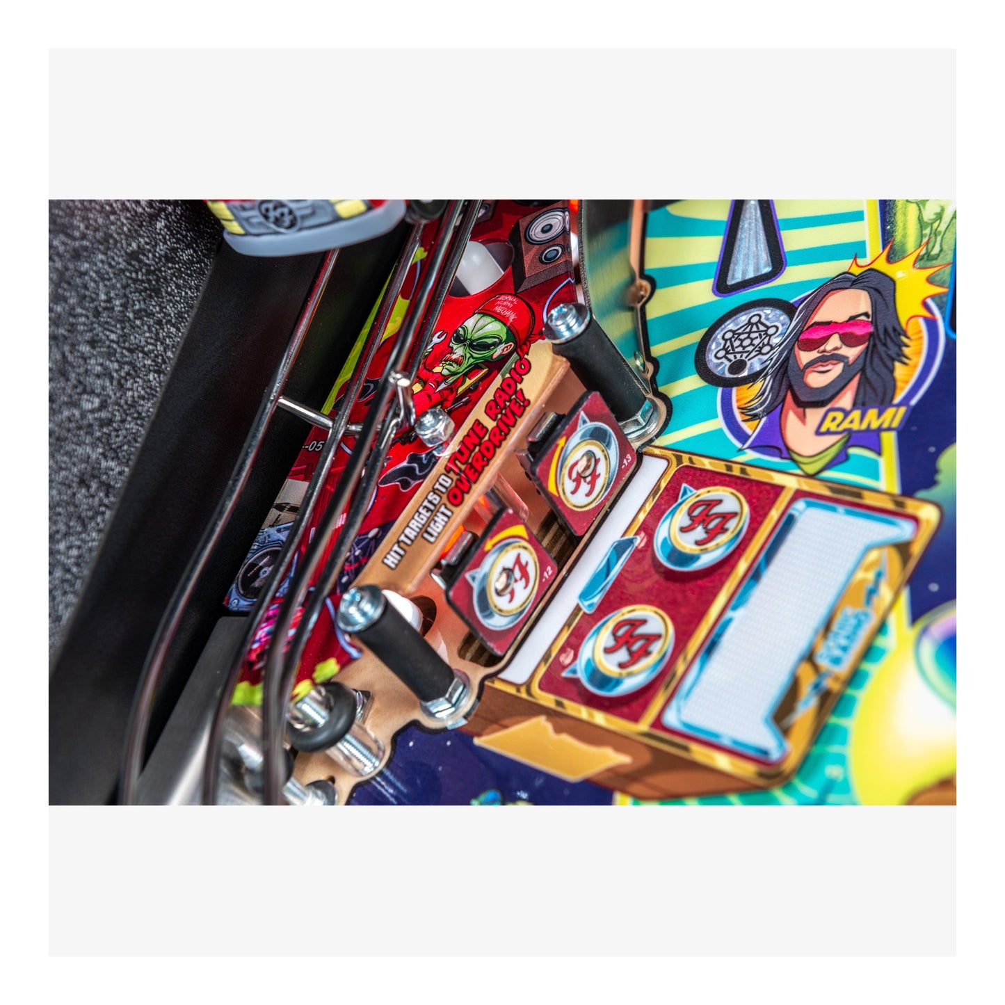 Close-up of a colorful pinball machine with detailed artwork and controls.