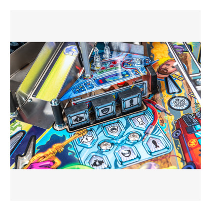 Close-up of a colorful pinball machine with various components and artwork.