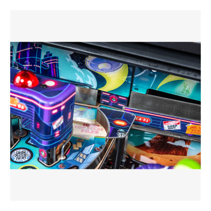 Close-up of a pinball machine with colorful design and neon lights.