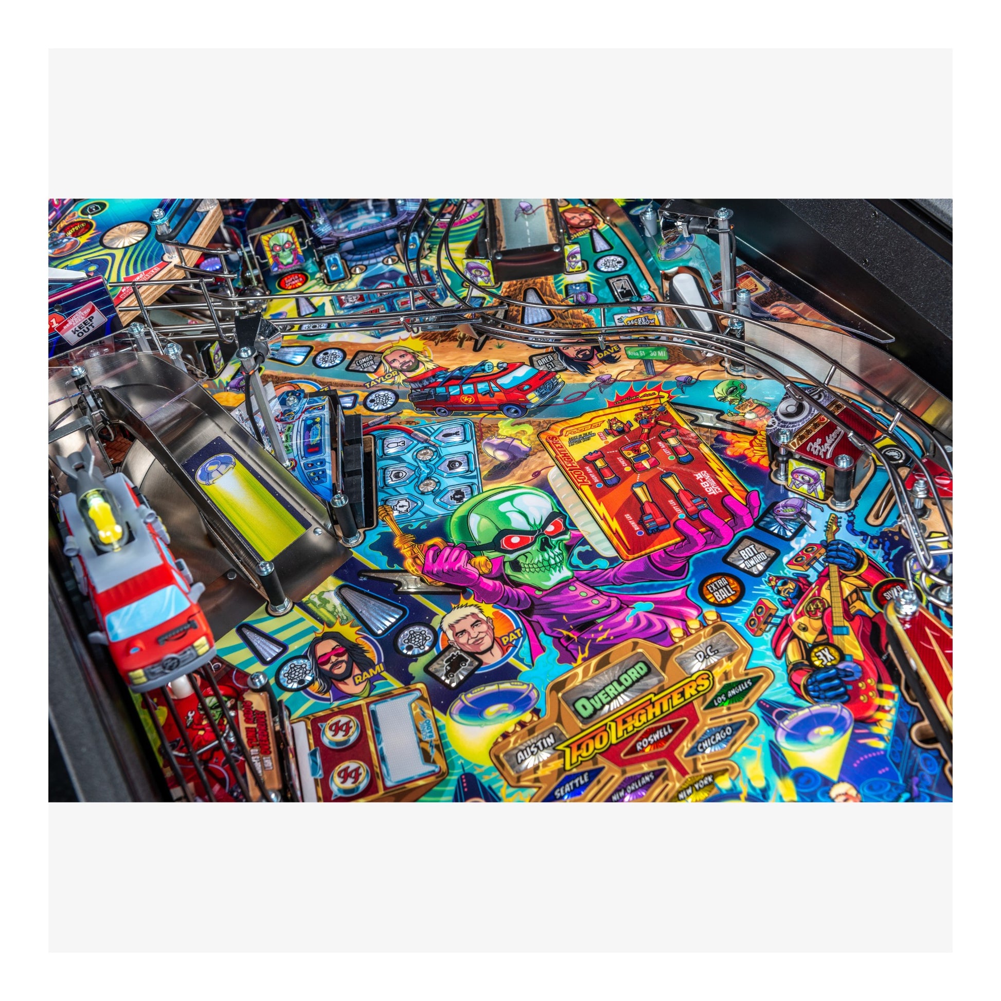 Colorful pinball machine with various symbols and characters on the playing field.