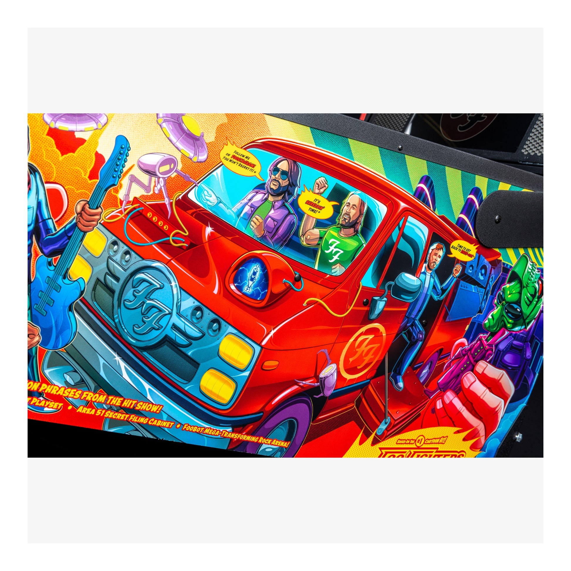 Colorful pinball machine artwork with a red car and animated characters.