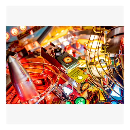 Close-up of a pinball machine with colorful lights and components.