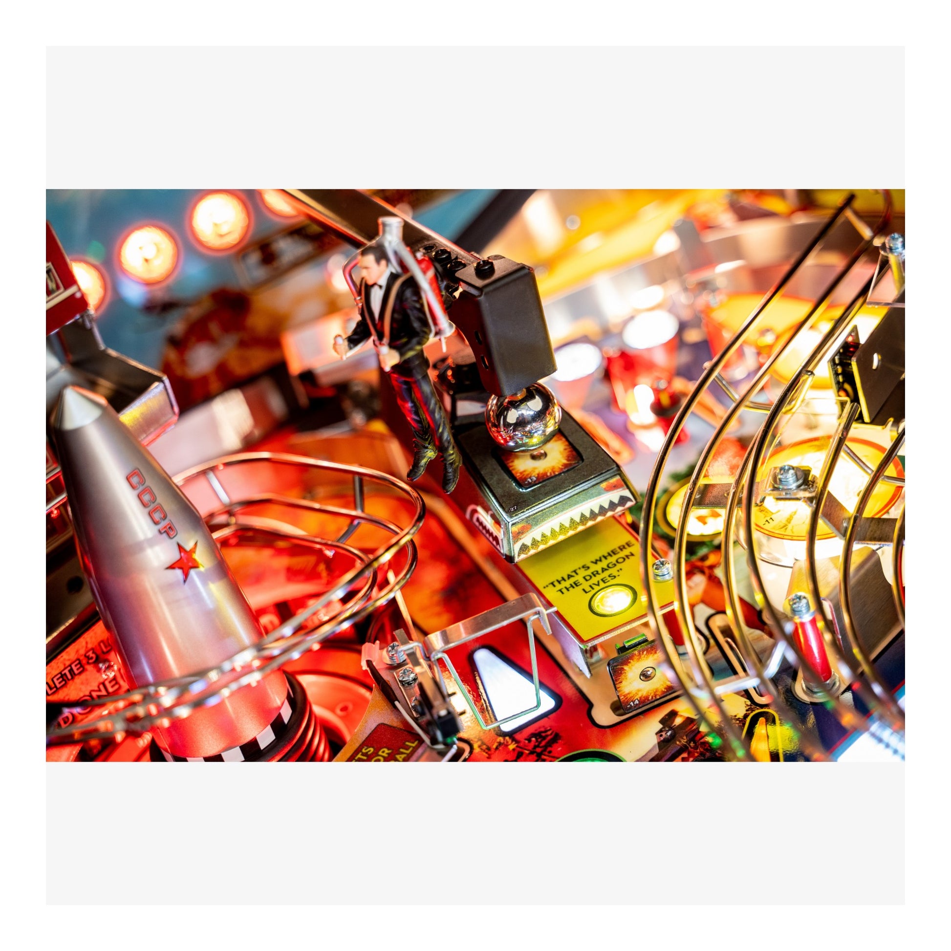 Close-up of a pinball machine with vibrant colors and mechanical components.