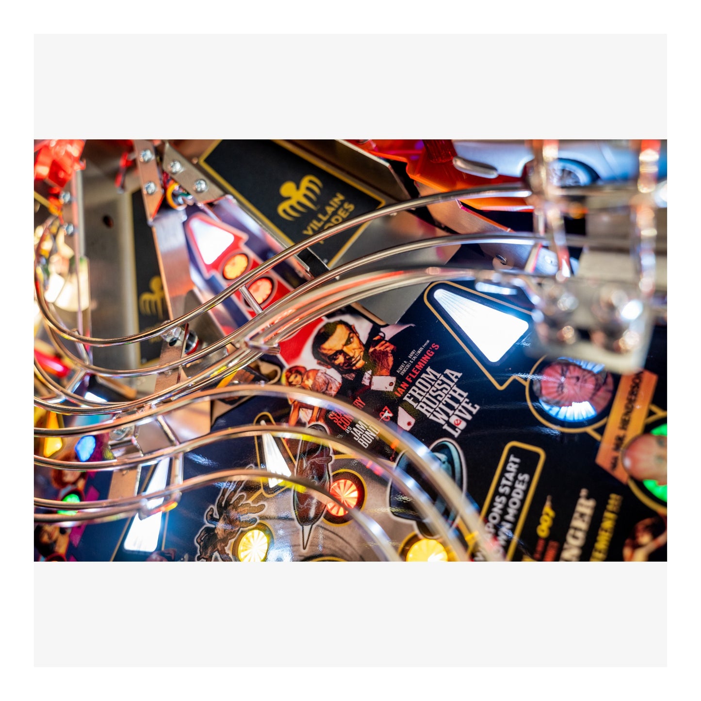 Close-up of a pinball machine with colorful lights and details