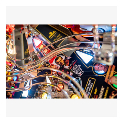 Close-up of a pinball machine with colorful lights and details