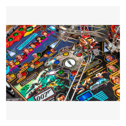 Close-up of a pinball machine with colorful artwork and characters on the playfield.