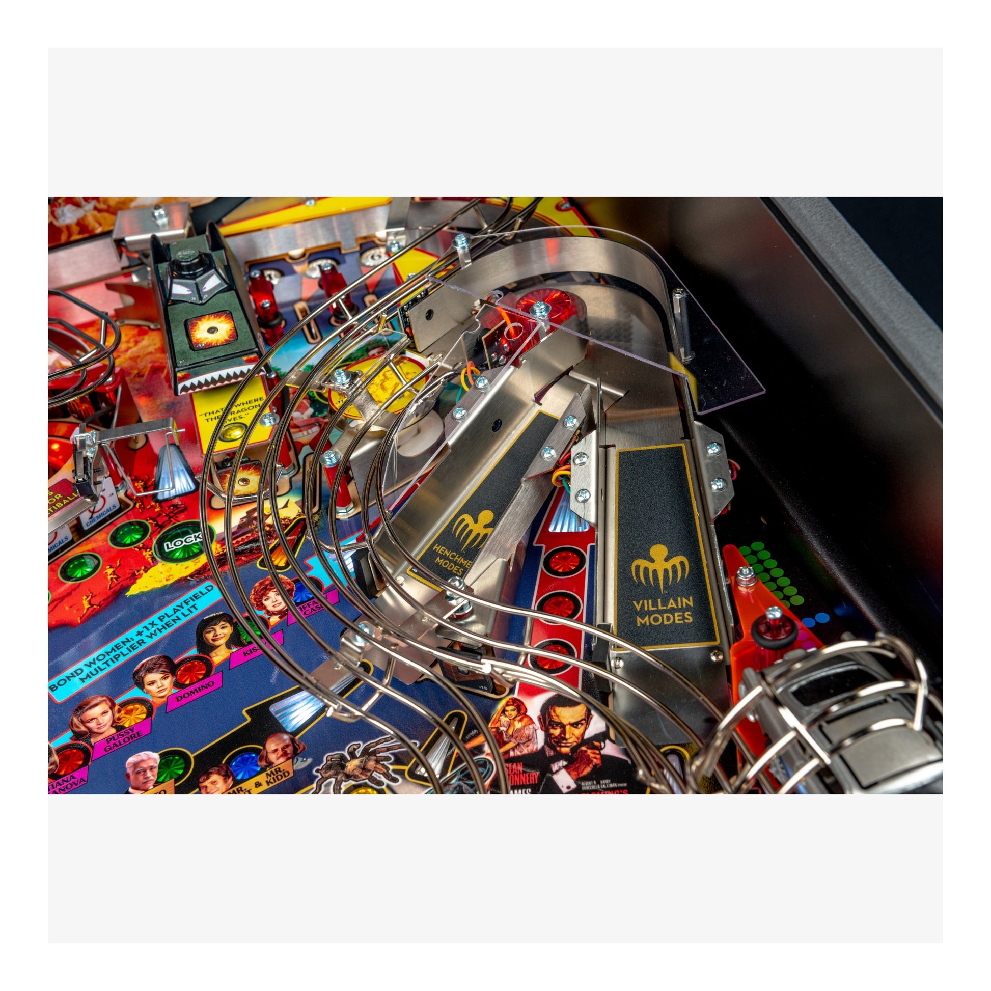 Close-up of a pinball machine with colorful artwork and metal components.