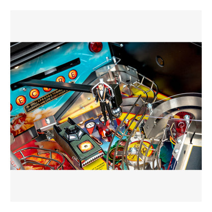 Close-up of a pinball machine with colorful playfield and mechanical components.