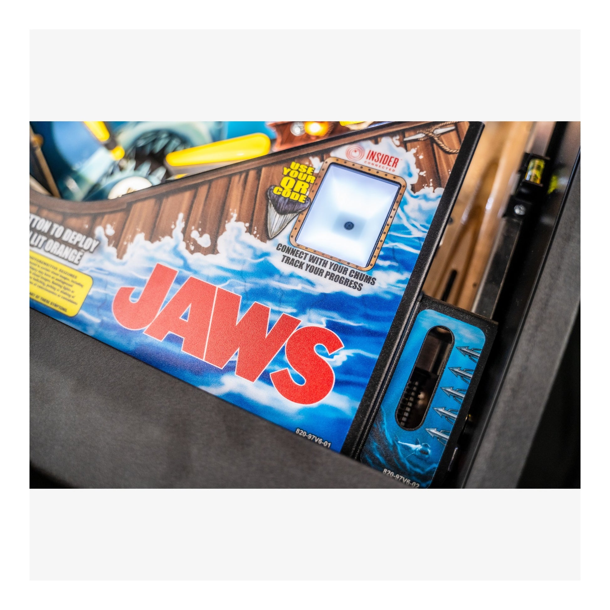 Pinball machine with 'Jaws' branding on a white background