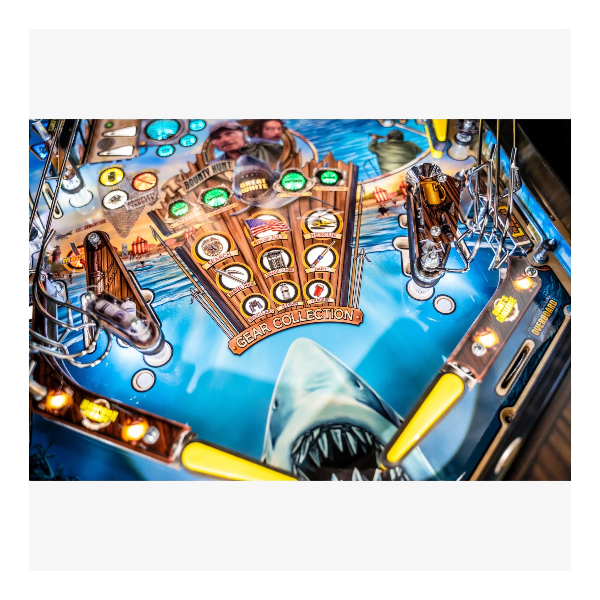 Close-up of a pinball machine with a shark and gold collection design.
