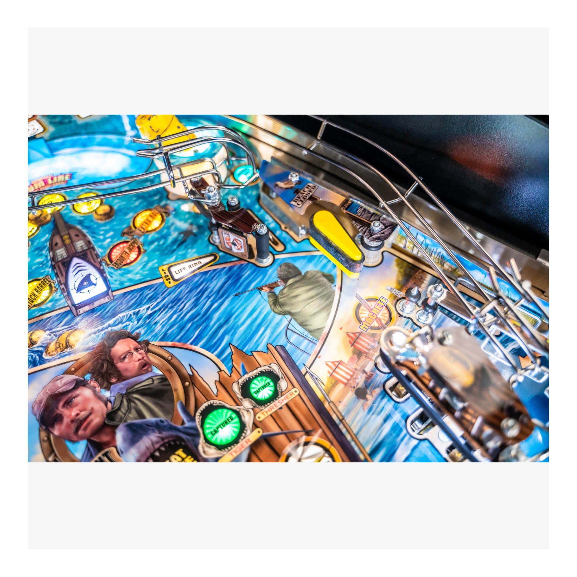 Close-up of a pinball machine with detailed artwork and playfield.