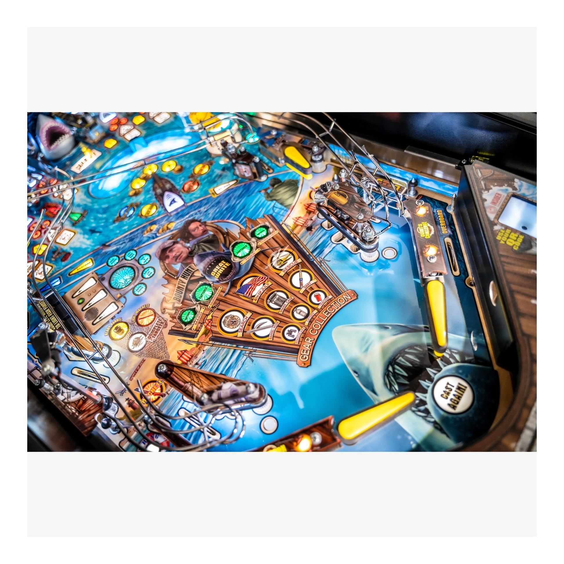 Close-up of a pinball machine with colorful design and various components.