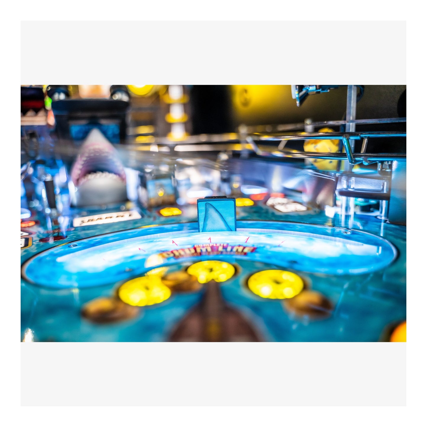 Close-up of a pinball machine with colorful playfield