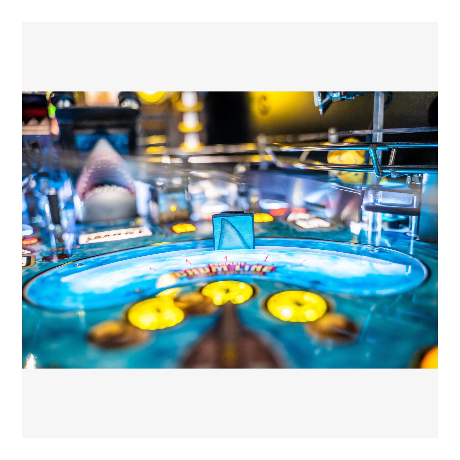 Close-up of a pinball machine with colorful playfield