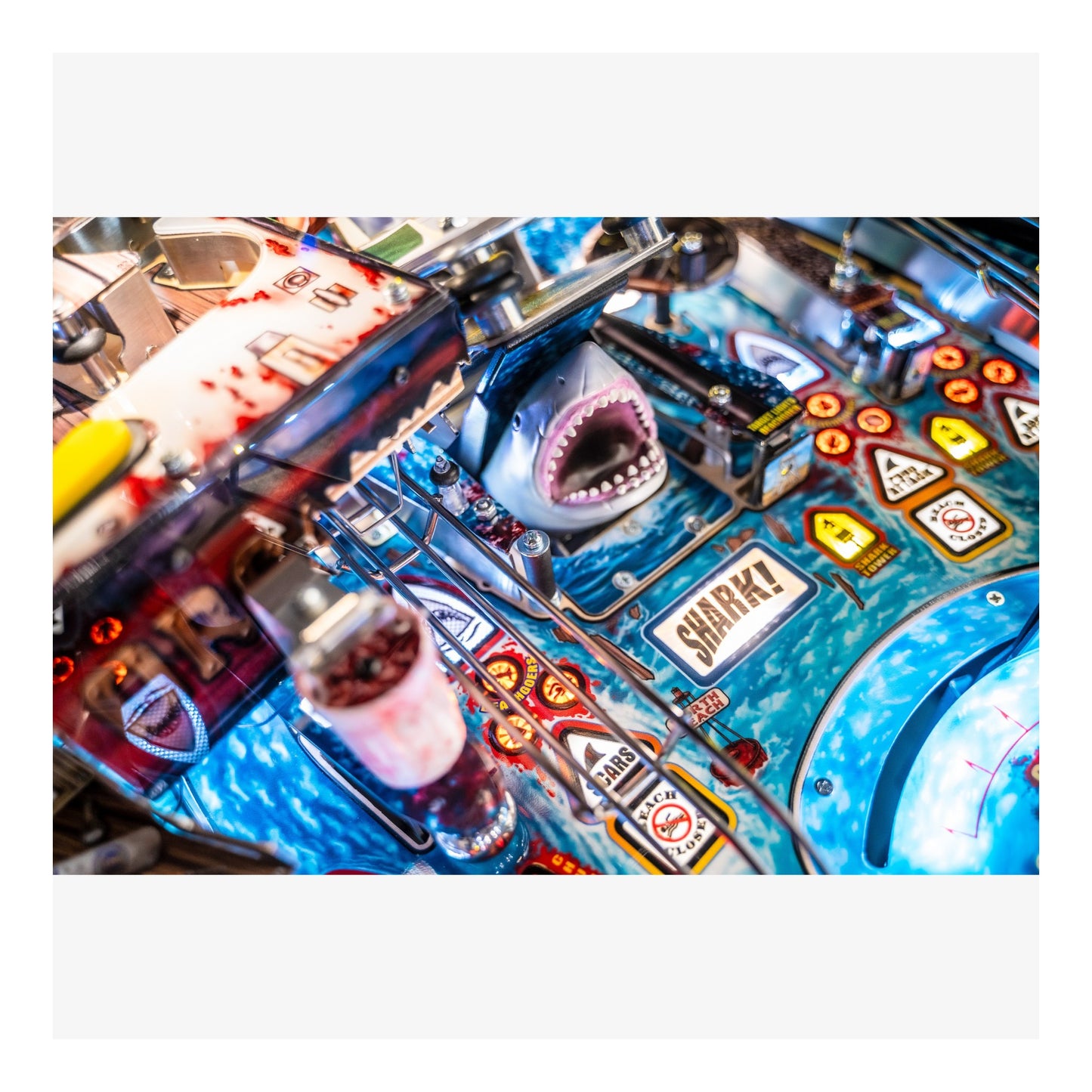 Close-up of a pinball machine with shark-themed design