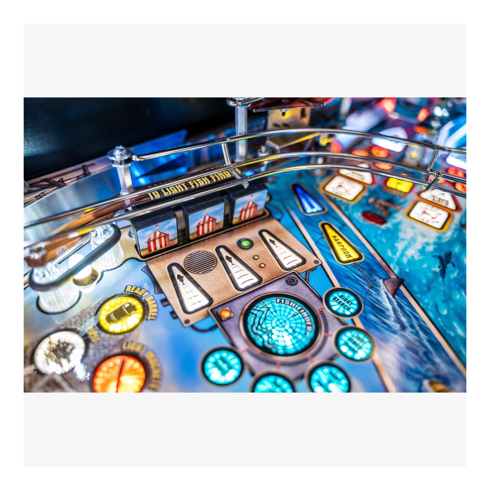 Close-up of a pinball machine with colorful lights and buttons
