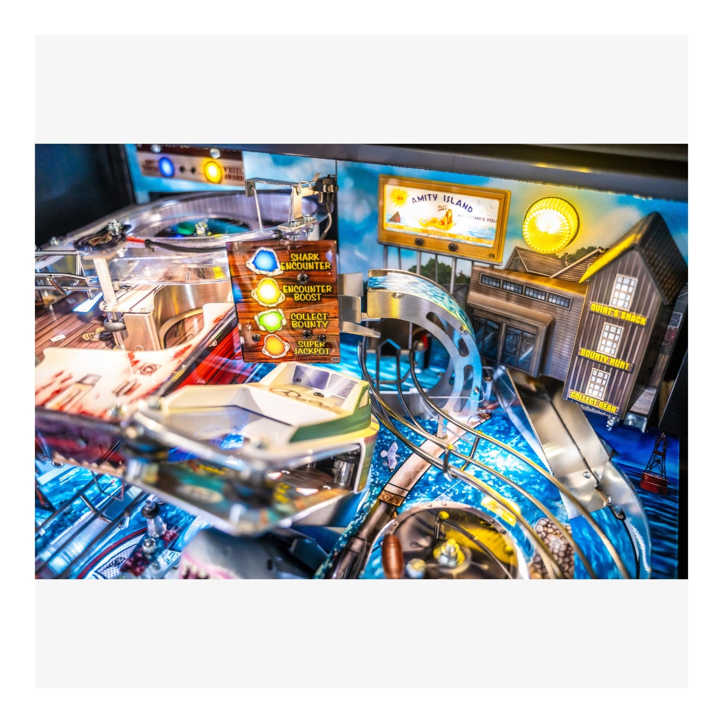Close-up of a pinball machine with colorful lights and details