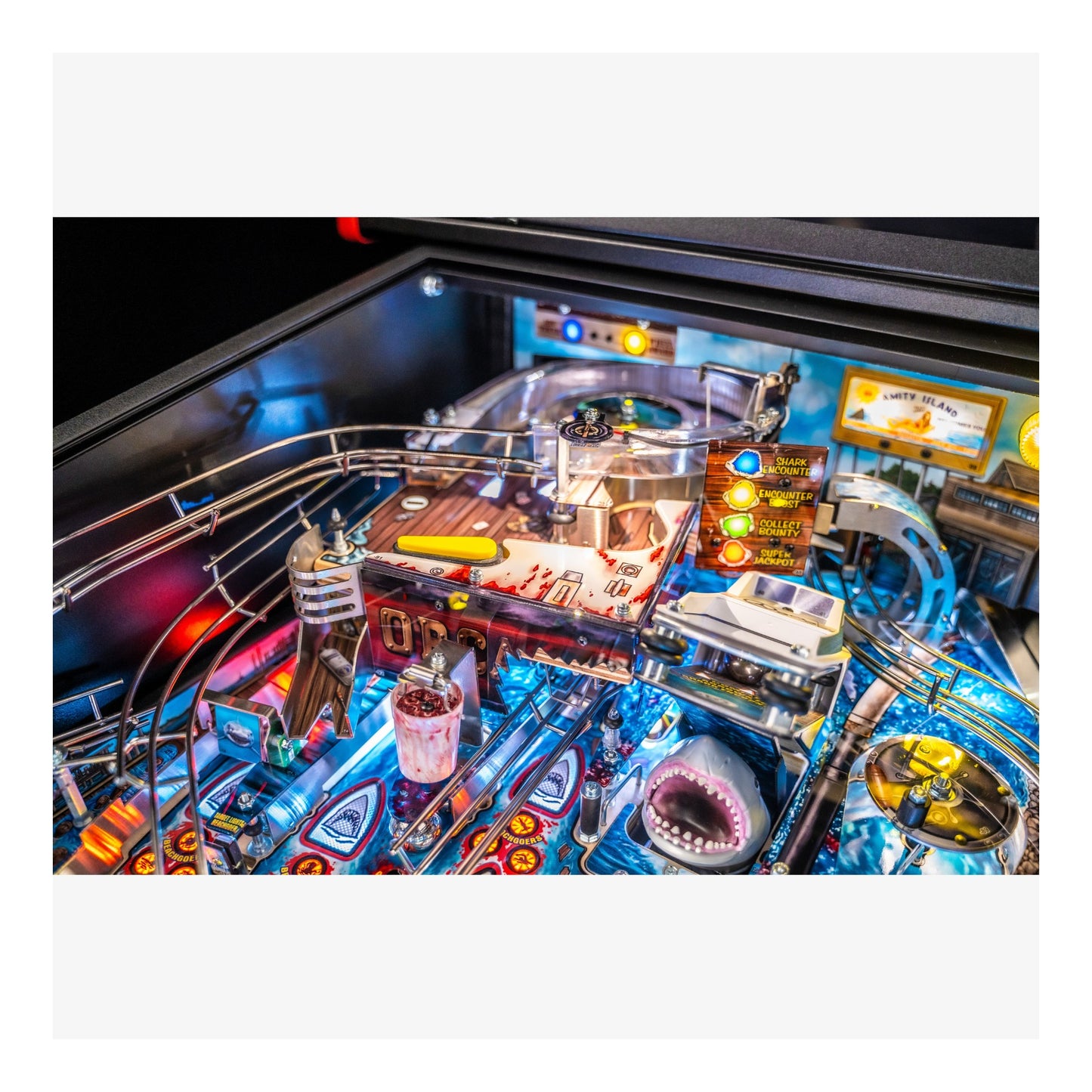 Close-up of a pinball machine with colorful playfield and various components.