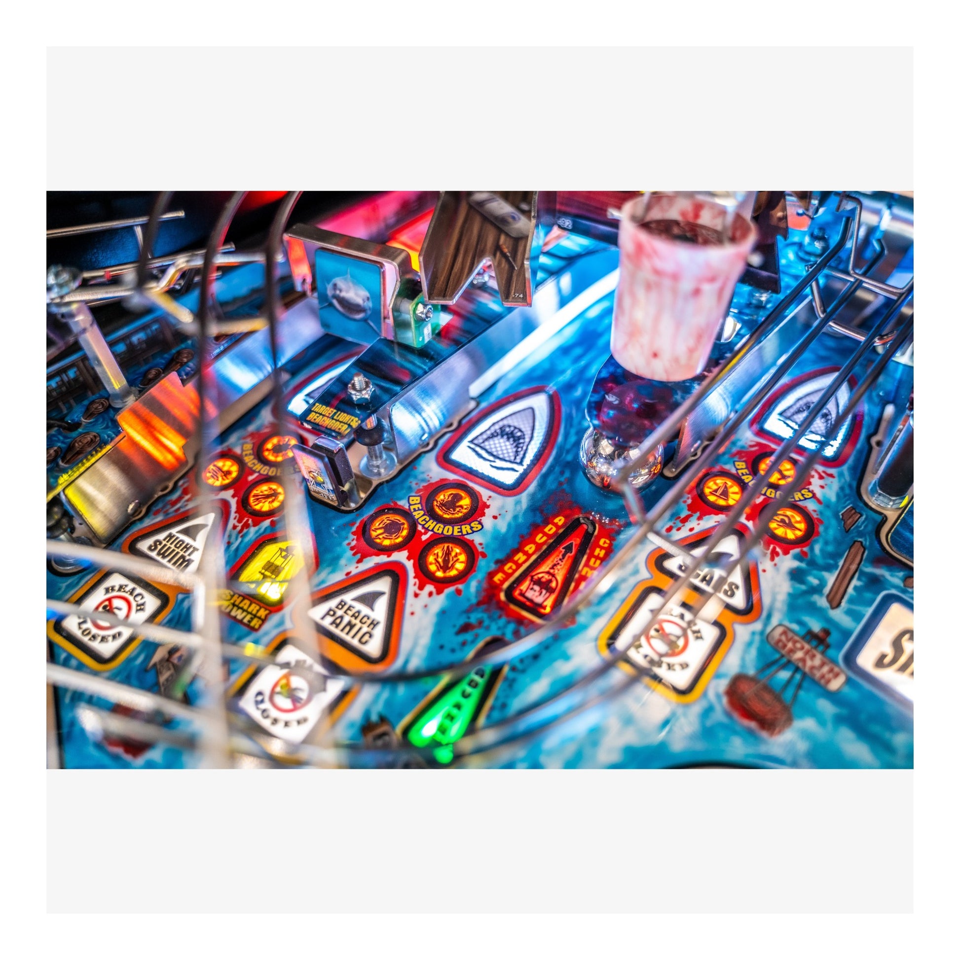 Close-up of a pinball machine with colorful design and lights