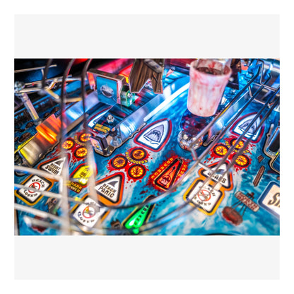 Close-up of a pinball machine with colorful design and lights