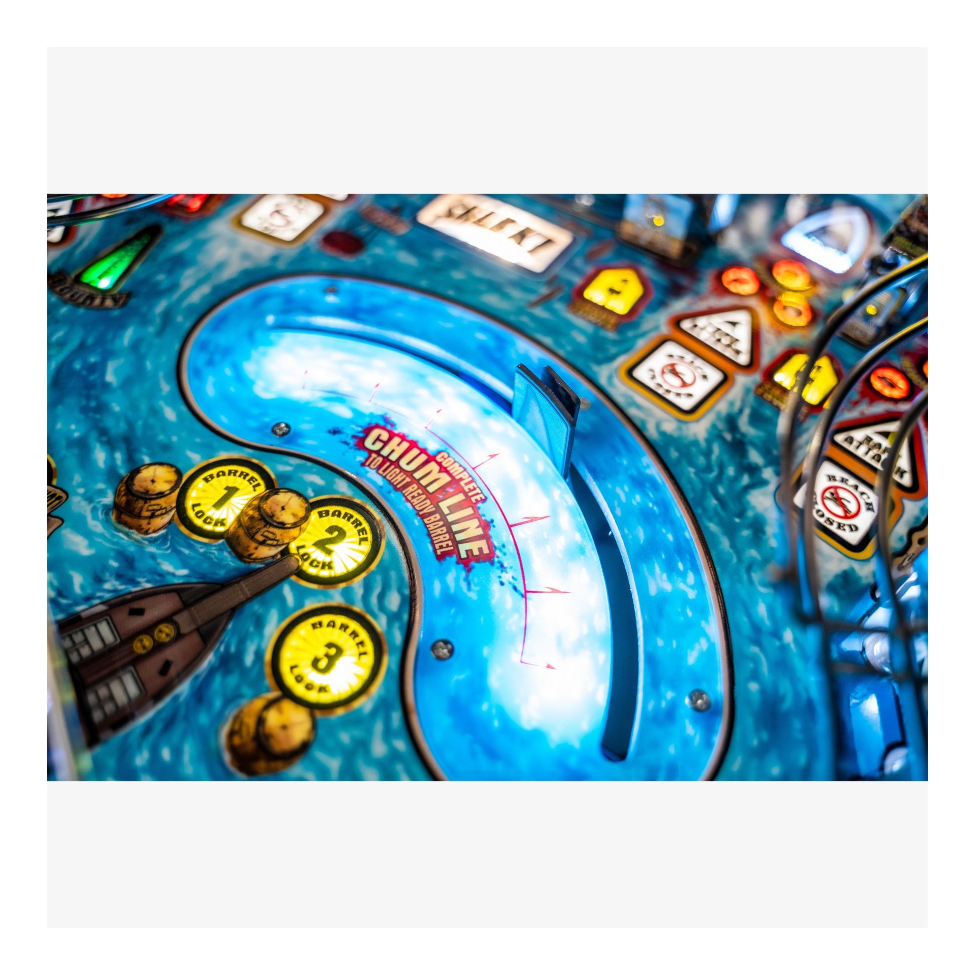 Close-up of a pinball machine with colorful design and text