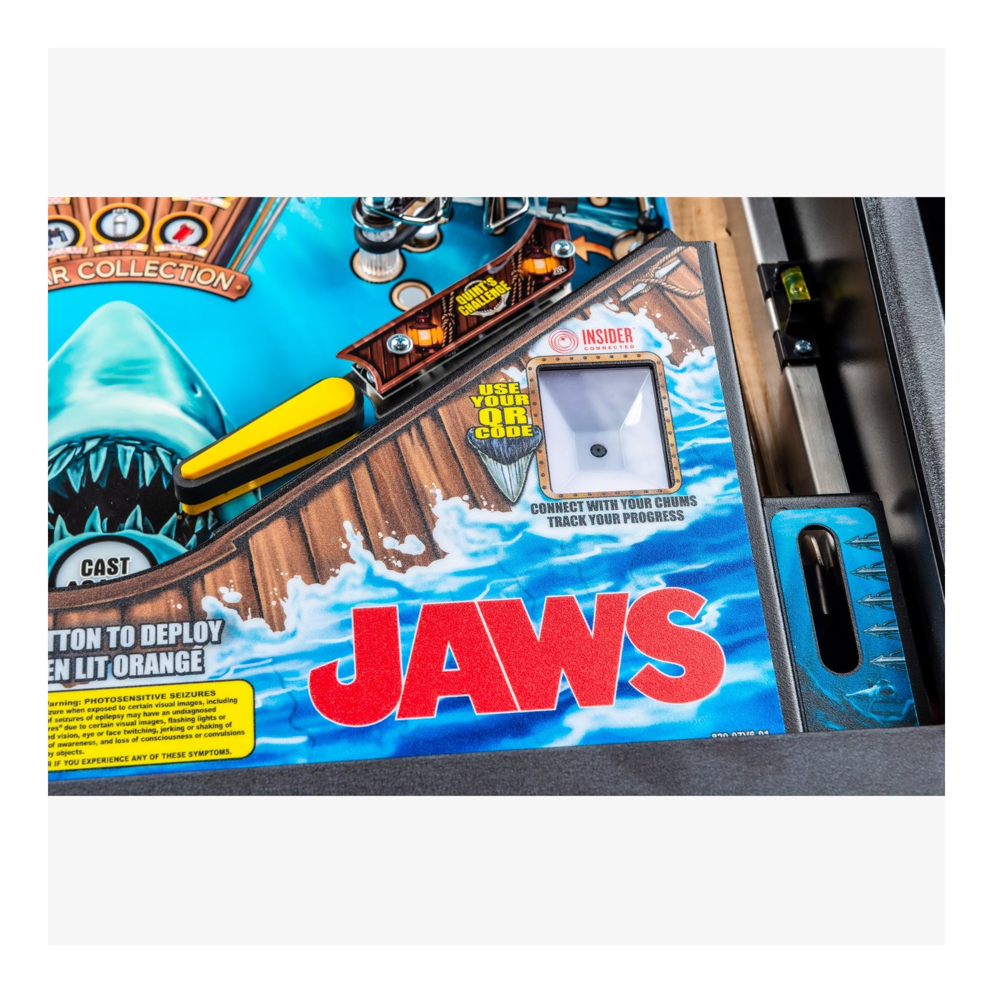 Pinball machine with 'JAWS' branding on a blue and red design
