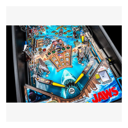 Pinball machine with 'Jaws' theme featuring a shark and vintage arcade design.