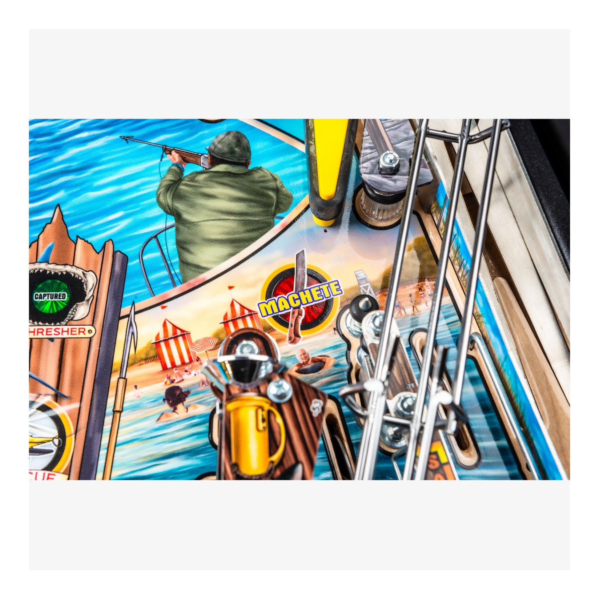 Close-up of a pinball machine with a colorful design featuring a man on a boat and various game elements.