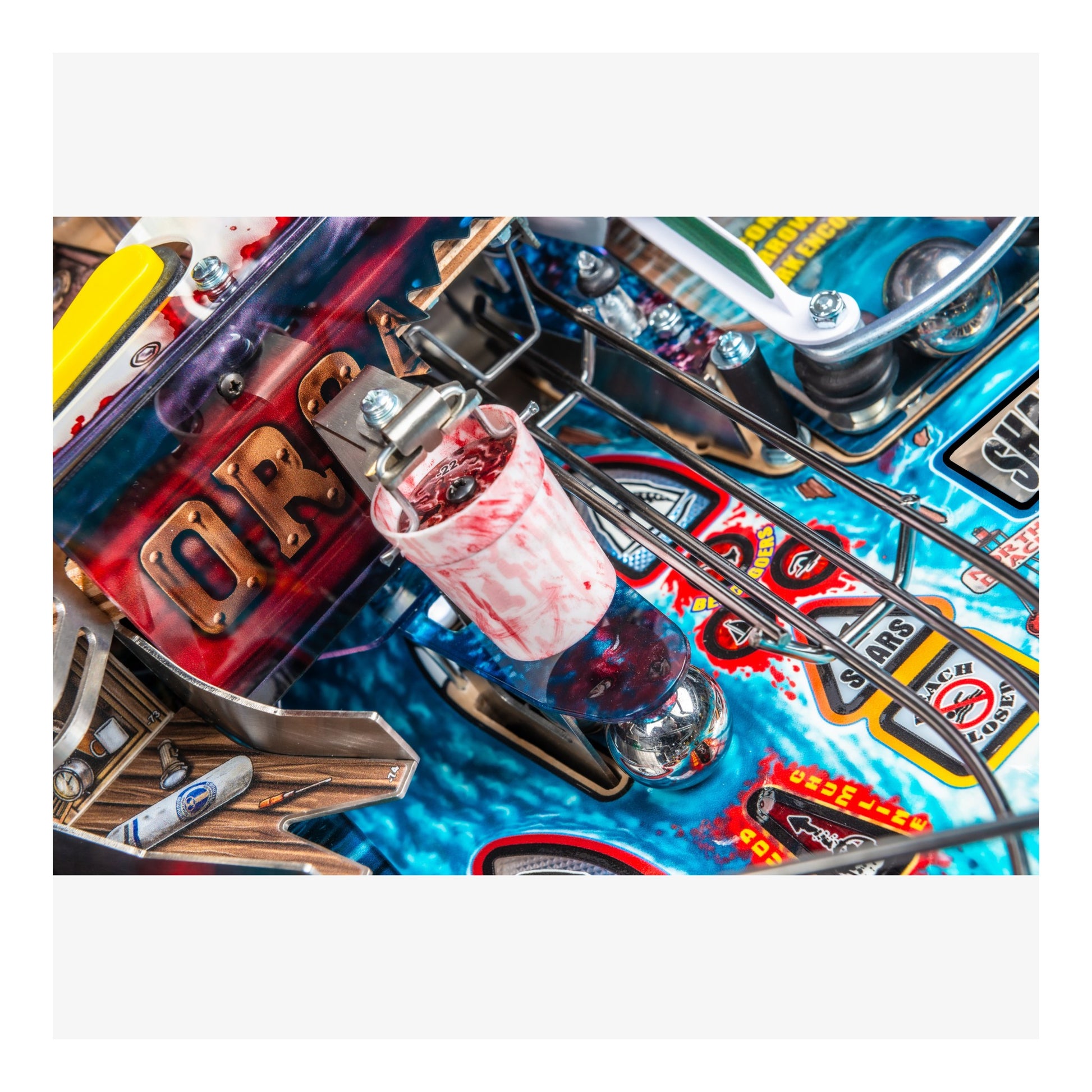 Close-up of a colorful pinball machine with various components and graphics.