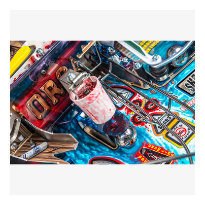 Close-up of a colorful pinball machine with various components and graphics.