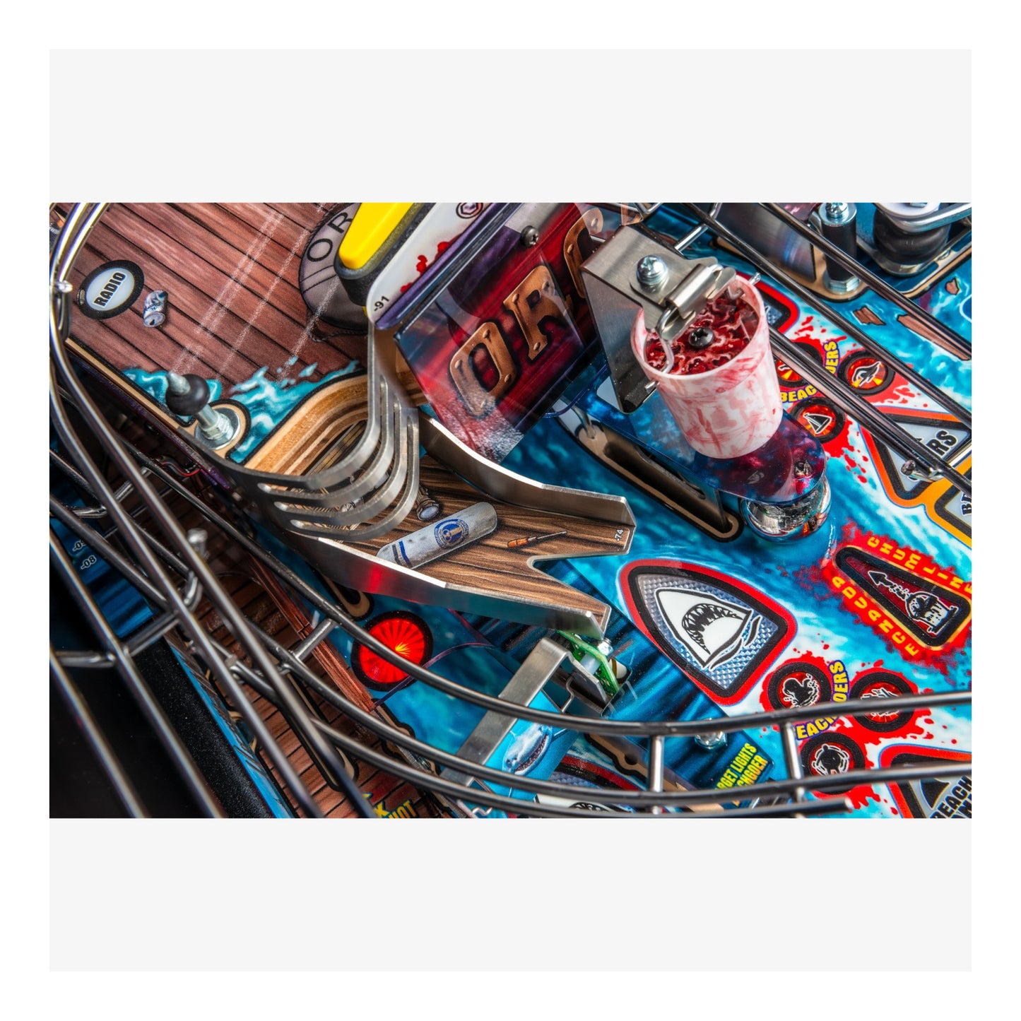 Close-up of a pinball machine with colorful marquee and playfield