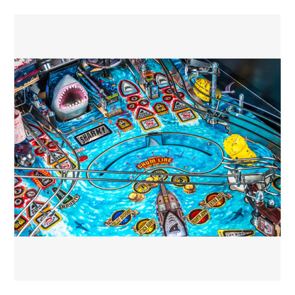 Close-up of a pinball machine with shark-themed design