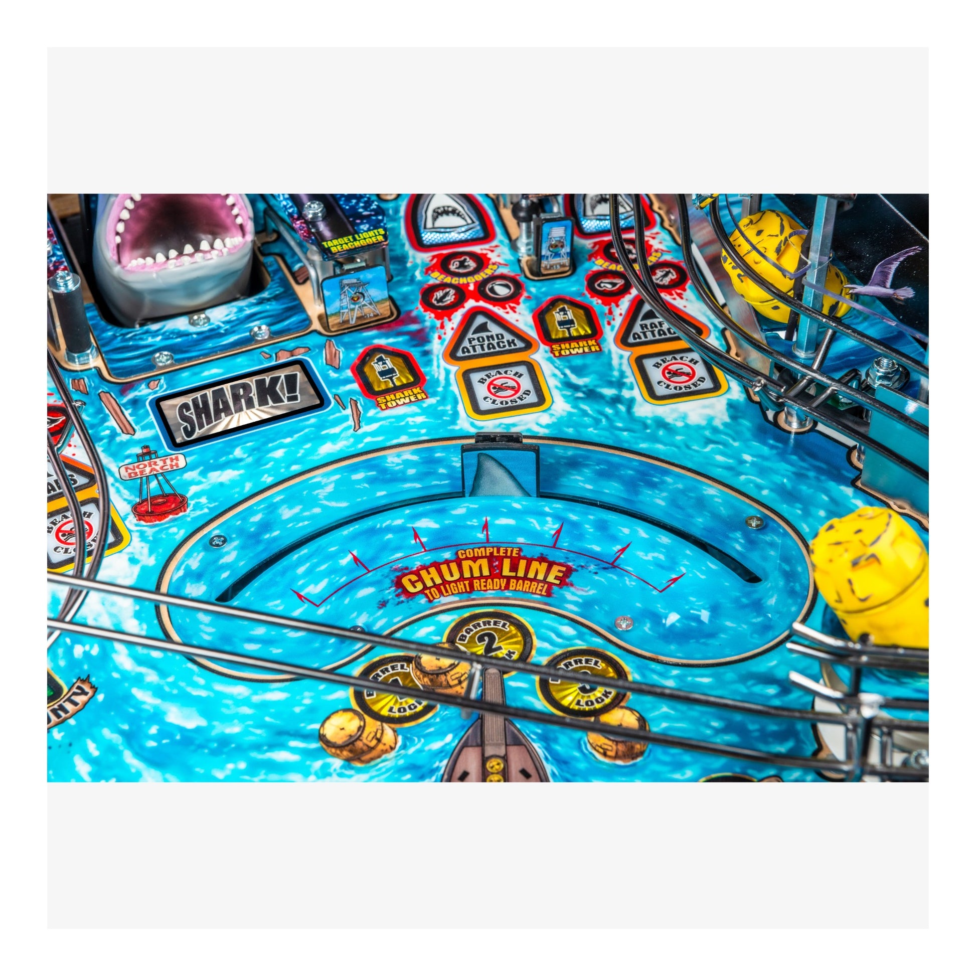 Close-up of a pinball machine with colorful design and 'Shark' and 'Chumline' branding.
